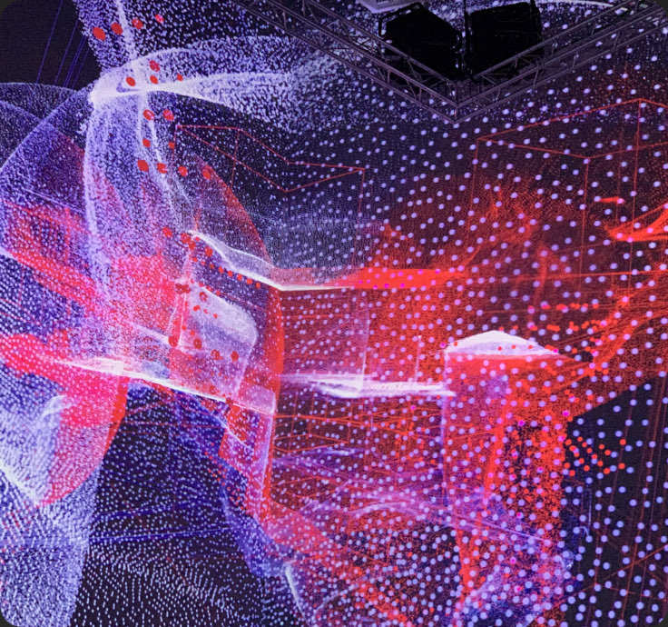 A light installation of red and violet points forming organic, architectural shapes — Guggenheim Museum, Bilbao, Spain